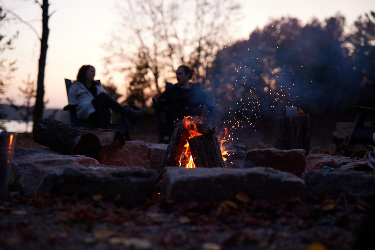 Guests gathered around a campfire at Dimensions Retreats