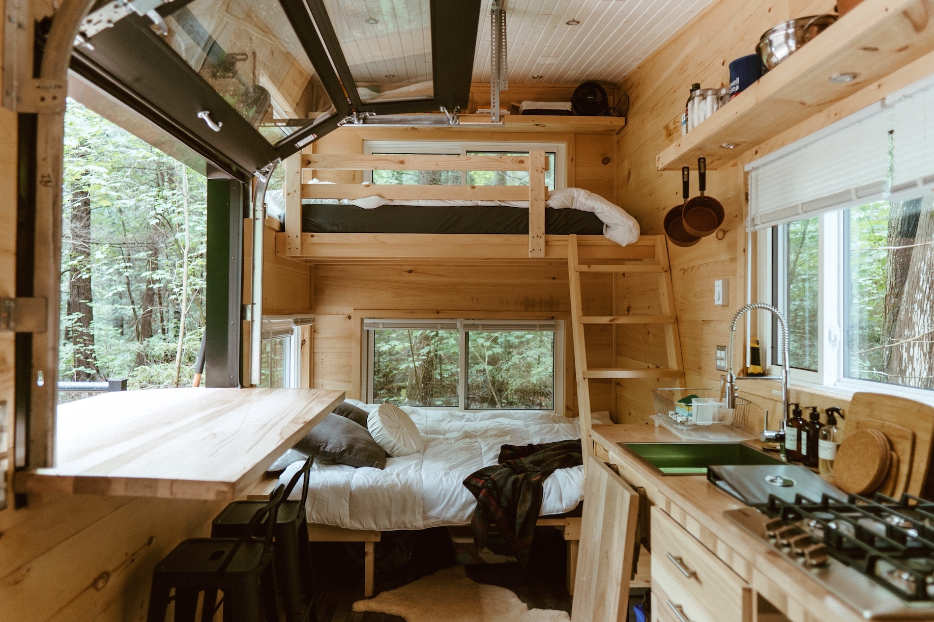 A light-filled off-grid cabin surrounded by forest